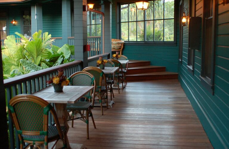 Outside lanai with table and chairs at tropical hotel retreat.