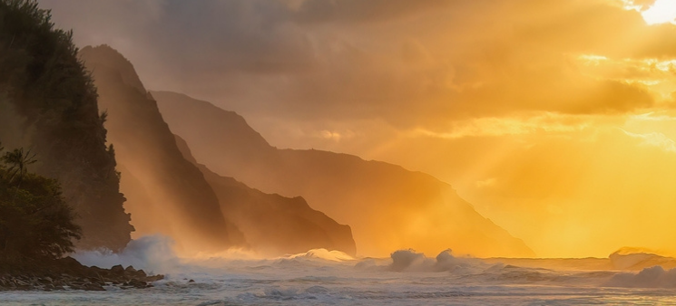 A beautiful shot of the silhouette of rocky cliffs on Kauai island during the sunset