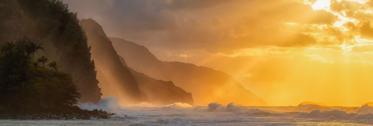 A beautiful shot of the silhouette of rocky cliffs on Kauai island during the sunset