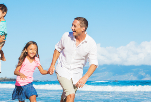 Family of four playing on beach