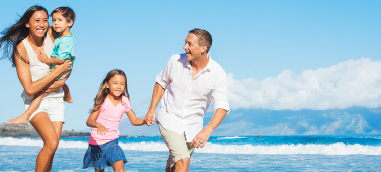 Family of four playing on beach