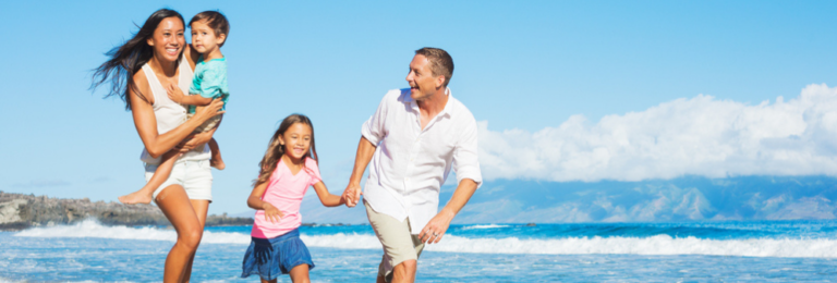 Family of four playing on beach