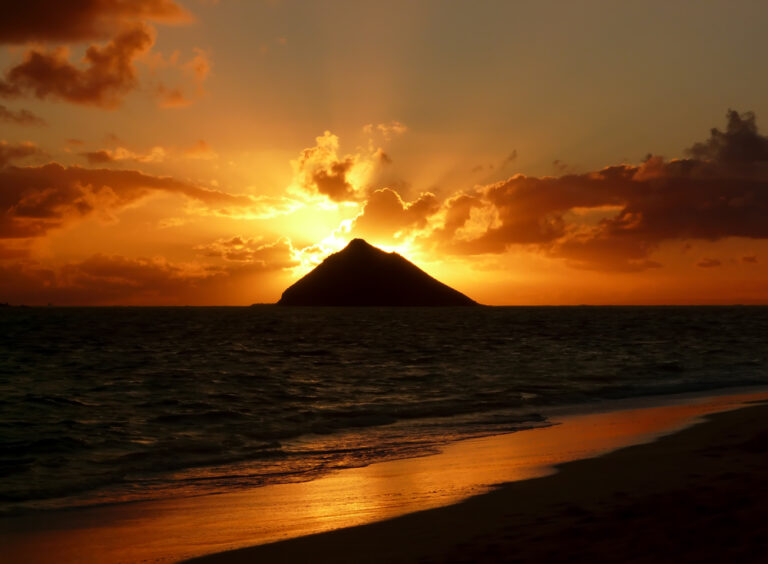 Warm tropical sunrise over an island at Lanikai Beach, Oahu, Hawaii.