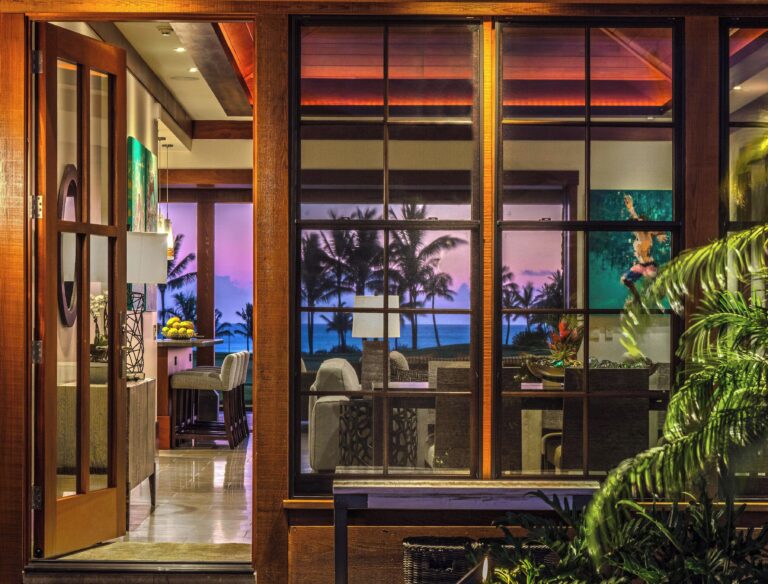 luxury villa, wooden beams, large glass window, sunset outside