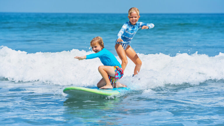 boy and girl surfing
